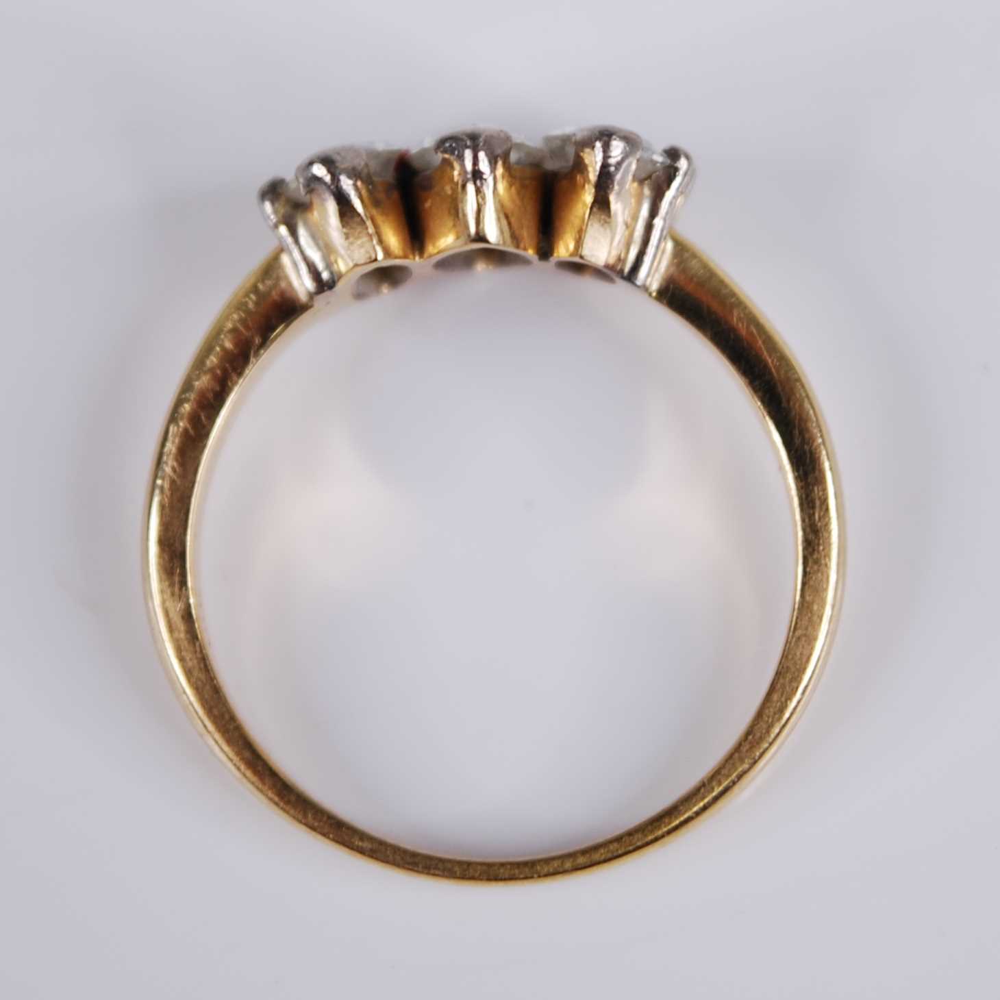 A yellow metal diamond three stone ring, the claw set marquise cut diamonds in a line setting, - Image 5 of 5