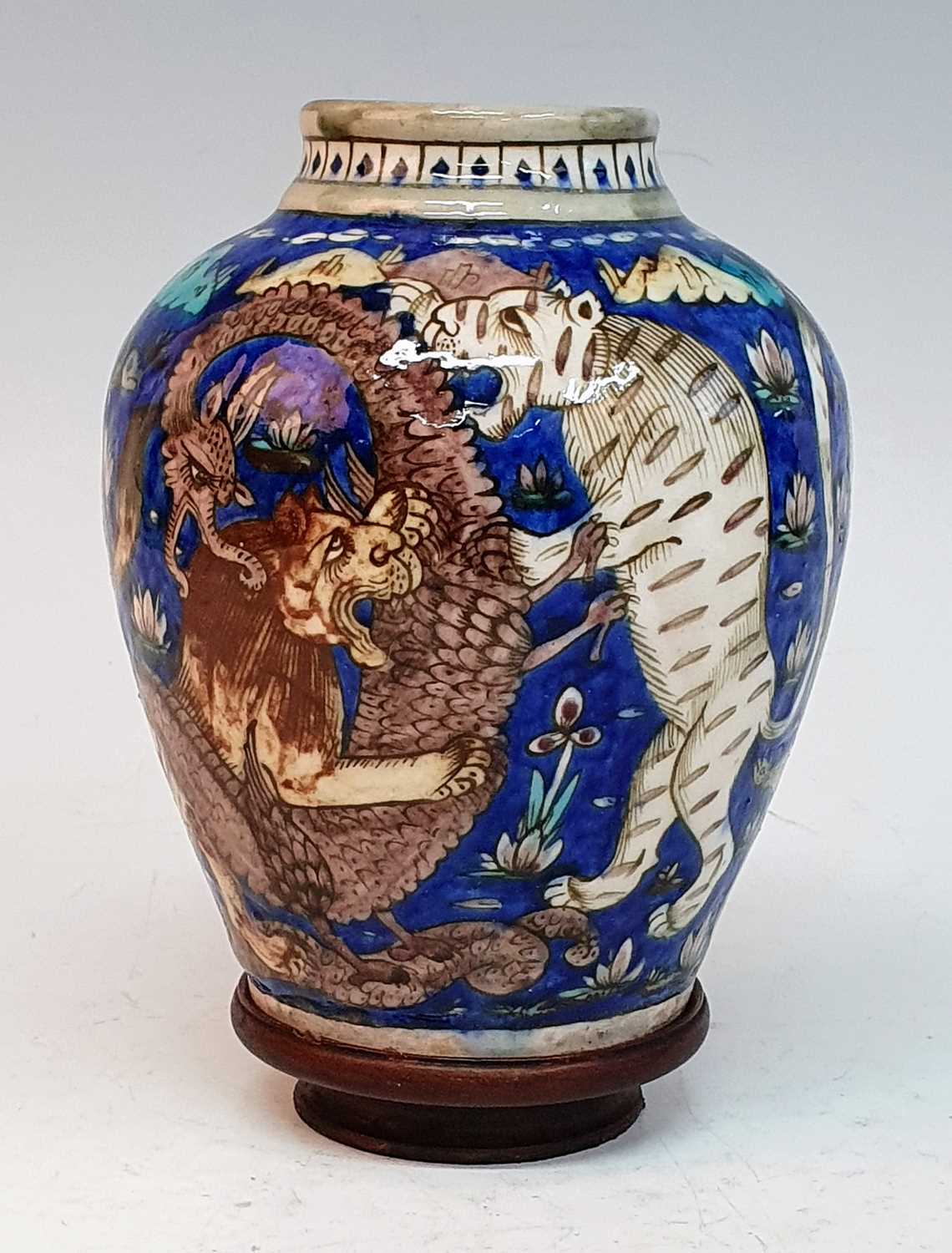 A 19th century Persian Qajar earthenware vase, decorated with fighting animals upon a cobalt ground, - Image 2 of 5
