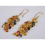 A pair of contemporary yellow metal multi-sapphire set ear pendants, the bezel set oval stones in