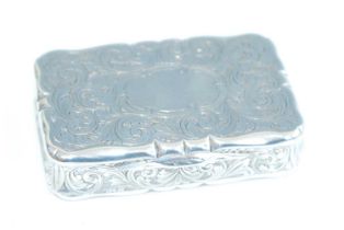 A Victorian silver snuff box, of shaped rectangular form, all-over finely scroll engraved with