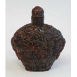 A Chinese amber snuff bottle, profusely carved with birds amongst flowers, h.9cm