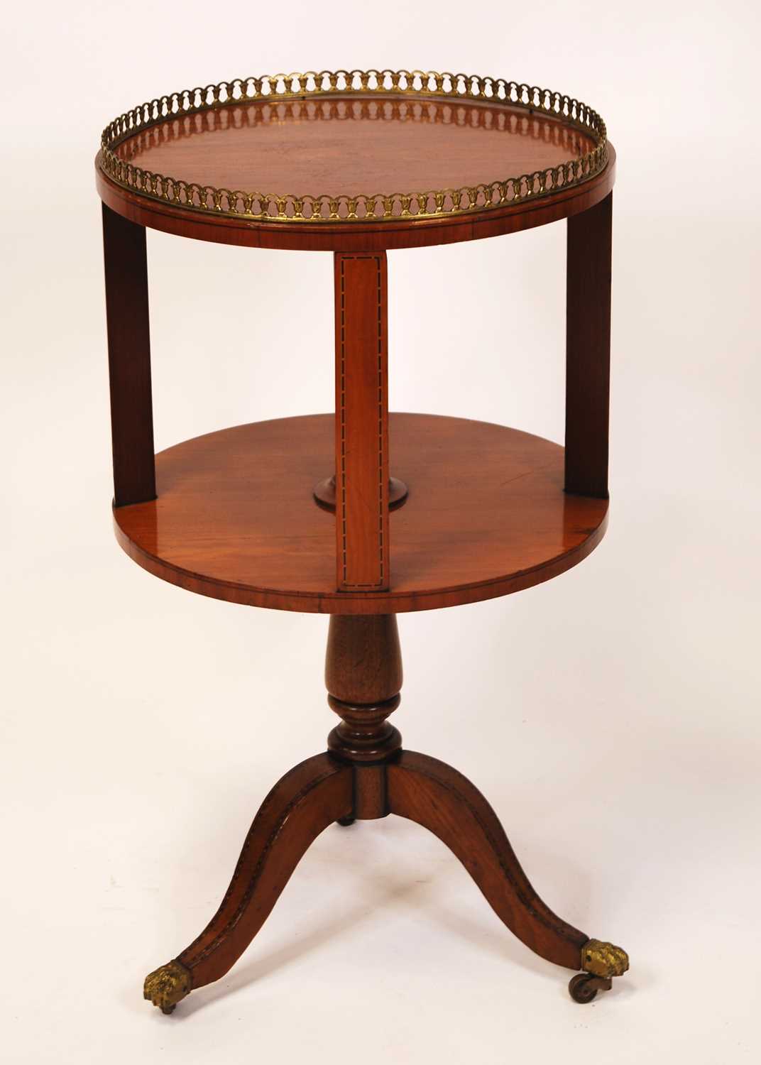 A circa 1900 satinwood circular book table, having a pierced brass gallery, chequer line inlay,