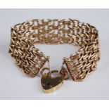 A 9ct gold gatelink bracelet, having heart shaped padlock clasp with safety chain, sponsor B&S,