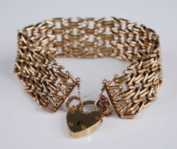 A 9ct gold gatelink bracelet, having heart shaped padlock clasp with safety chain, sponsor B&S,