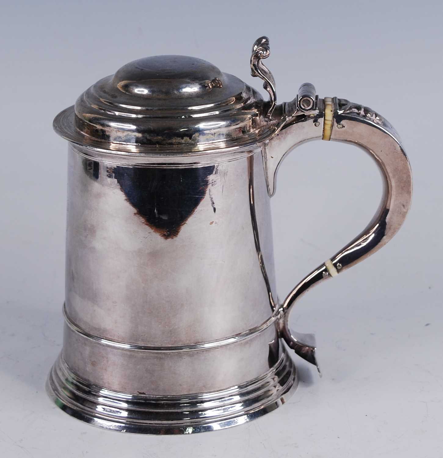 A George I silver lidded tankard, of flaring cylindrical form, the domed cover with scroll - Image 3 of 10