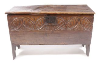 A mid-17th century joined oak plank coffer, the hinged cover on original steel loop hinges, the