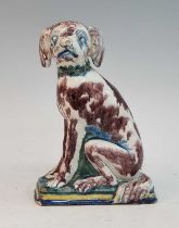 An 18th century Delft polychrome tin glazed earthenware moneybox, in the form of a seated dog, h.