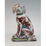 An 18th century Delft polychrome tin glazed earthenware moneybox, in the form of a seated dog, h.