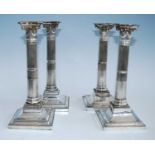 Two pairs of 19th century silver plated candlesticks, each stop fluted column standing upon beaded