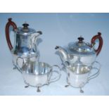 A mid-20th century silver four-piece tea set, comprising teapot, hot water pot, sugar and cream,