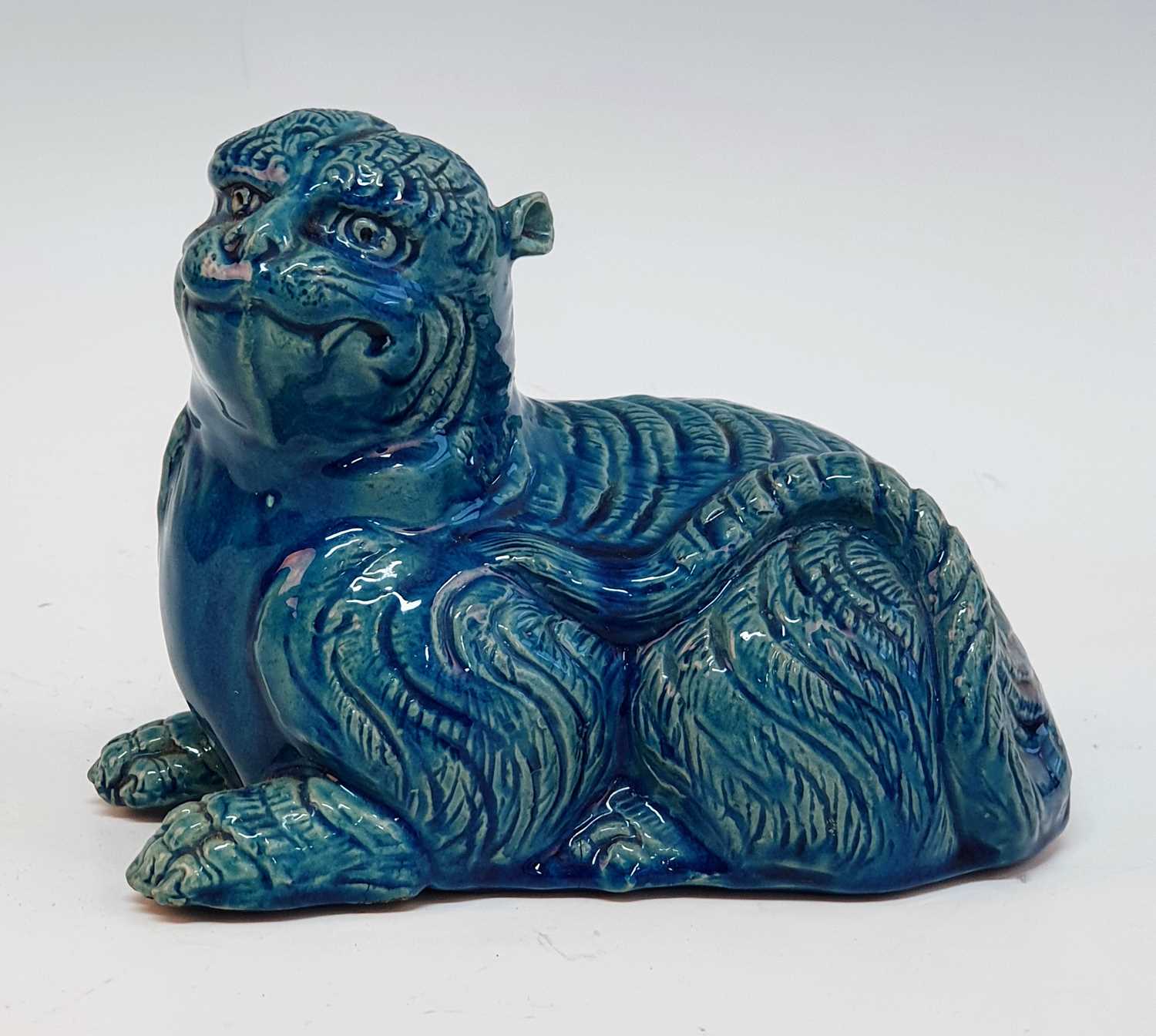 A 19th century Chinese turquoise glazed model of a tiger, shown in recumbent pose, h.14cm There is a