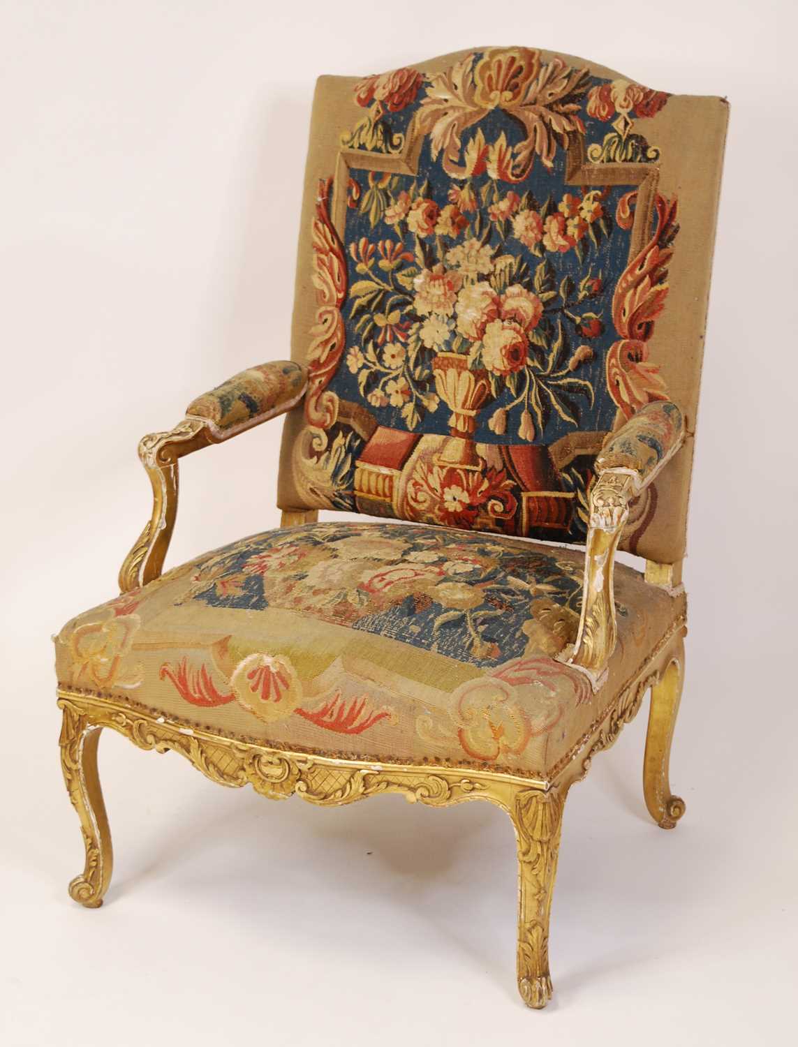 A 19th century French giltwood framed and needlework tapestry upholstered fauteuil, in the Régence