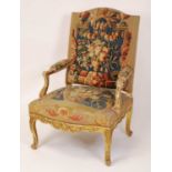 A 19th century French giltwood framed and needlework tapestry upholstered fauteuil, in the Régence