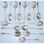 A matched set of fifteen early 20th century silver caddy spoons, the shaped scroll-edged bowls