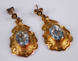 A pair of yellow metal Etruscan style aquamarine drop earrings, each featuring a central 11.15 x 7.