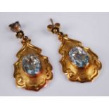 A pair of yellow metal Etruscan style aquamarine drop earrings, each featuring a central 11.15 x 7.