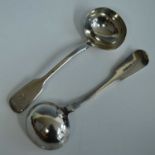 A matched pair of antique silver sauce ladles, in the Fiddle pattern with monogrammed terminals, one