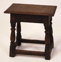 A circa 1700 oak joint stool, the plain rectangular top over chip carved frieze to ring turned and