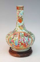 A 19th century Chinese Canton famille rose vase, the slender neck leading to a squat globular