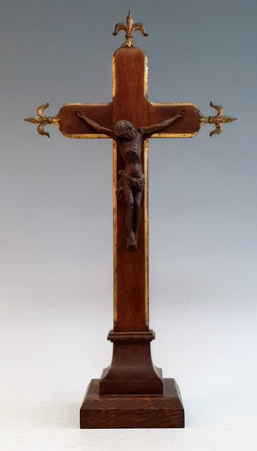 A Victorian parcel gilt carved oak crucifix, the corpus christi above a cavetto moulded base, h.