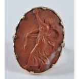 A yellow metal oval lava stone cameo ring, depicting a female figure in classical dress, with