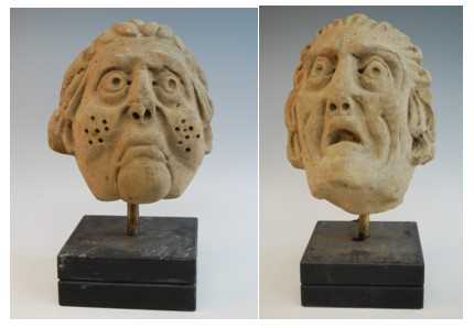 Two carved sandstone heads, probably 17th century, each later mounted upon a polished slate base,