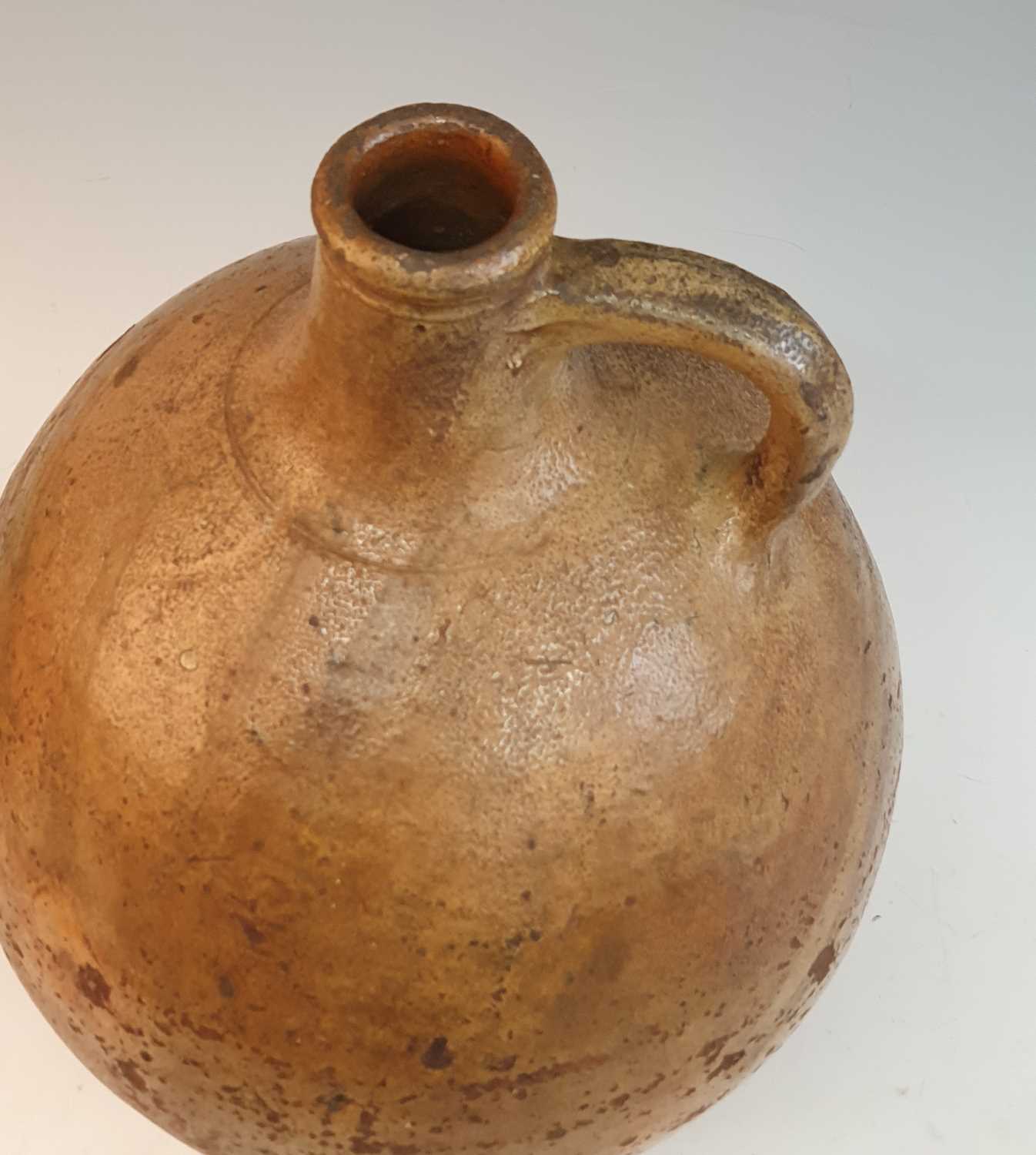 An early 18th century German salt glazed stoneware Bellarmine type flagon, of typical form, having a - Image 2 of 6