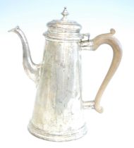 An Elizabeth II silver coffee pot, of plain tapering cylindrical form to a stepped base, the waisted