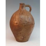 An early 18th century German salt glazed stoneware Bellarmine type flagon, of typical form, having a