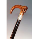 An early 20th century walking stick, having a carved yew handle in the form of a female head, half