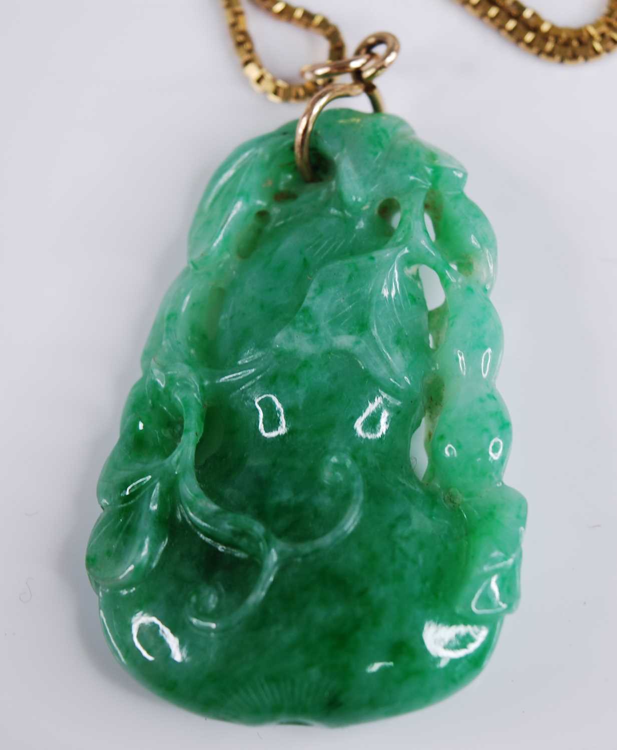 A Chinese carved green and celadon jade pendant, modelled as a gourd issuing leaves and foliage, h. - Image 2 of 7