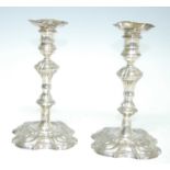 A near-pair of late 18th century silver table candlesticks, the stems of knopped and fluted form