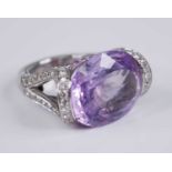 A contemporary French 18ct white gold, amethyst and diamond dress ring, arranged as a large oval cut