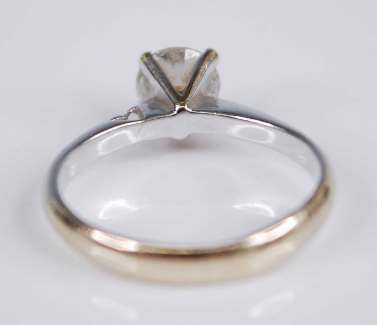 A white metal diamond solitaire ring, with a round brilliant cut diamond in a four-claw V shaped - Image 5 of 5