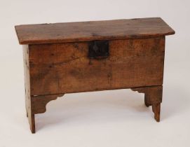 A 17th century boarded oak six-plank coffer, the hinged cover on replacement iron strap hinges and