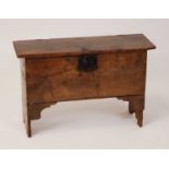 A 17th century boarded oak six-plank coffer, the hinged cover on replacement iron strap hinges and