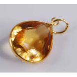 A contemporary yellow metal citrine set pendant, the pear cut citrine measuring approx 14 x 11.5 x