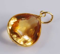 A contemporary yellow metal citrine set pendant, the pear cut citrine measuring approx 14 x 11.5 x