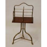 An Edwardian tubular brass and oak swivel book stand, having four divisions, raised on umbrella