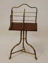 An Edwardian tubular brass and oak swivel book stand, having four divisions, raised on umbrella