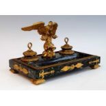 A 19th century French ormolu and patinated marble double encrier, surmounted by a spread eagle,