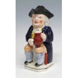 An early 19th century Staffordshire Enoch Wood type 'ordinary' Toby jug, shown holding a foaming