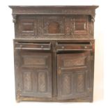 An early 18th century joined oak court cupboard, the frieze bearing date 1725, the upper section