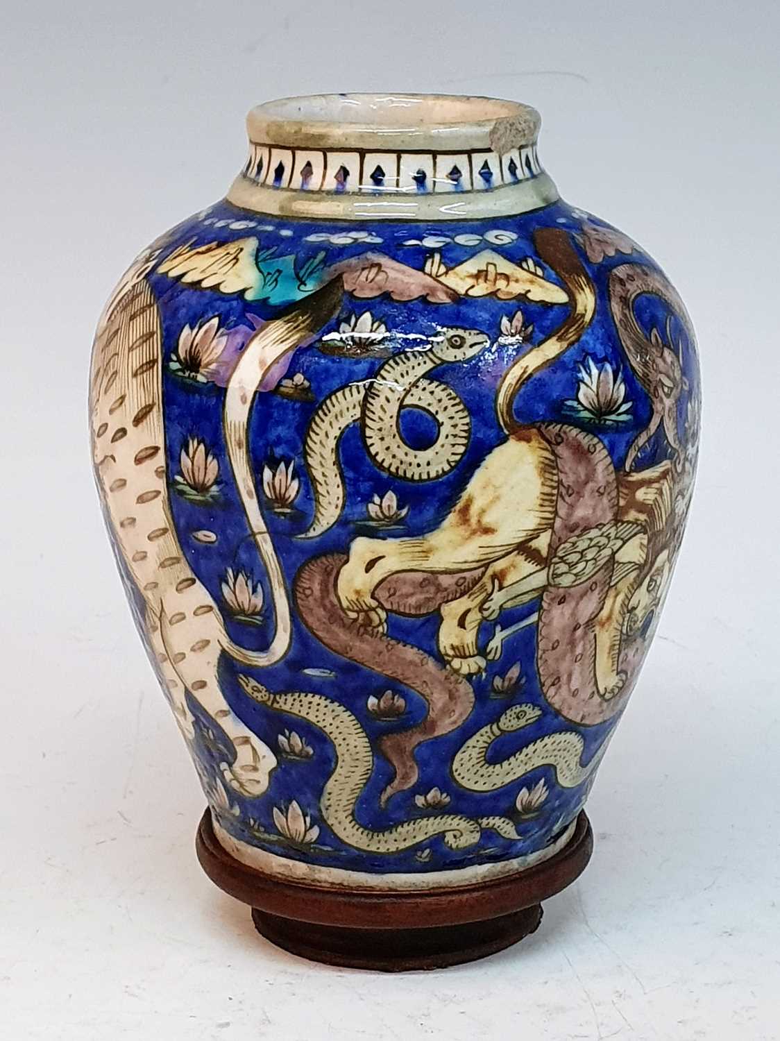 A 19th century Persian Qajar earthenware vase, decorated with fighting animals upon a cobalt ground, - Image 3 of 5