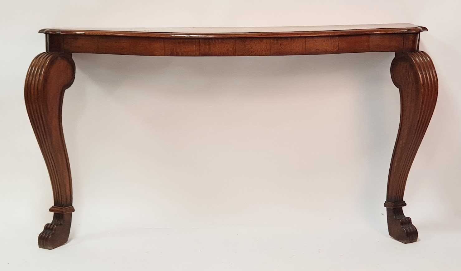 A Victorian oak serpentine front console table, the moulded top with pinched corners and raised on