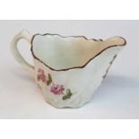 A circa 1780 Lowestoft porcelain 'Chelsea ewer' sauce boat, enamel decorated with flowers, h.5.5cm