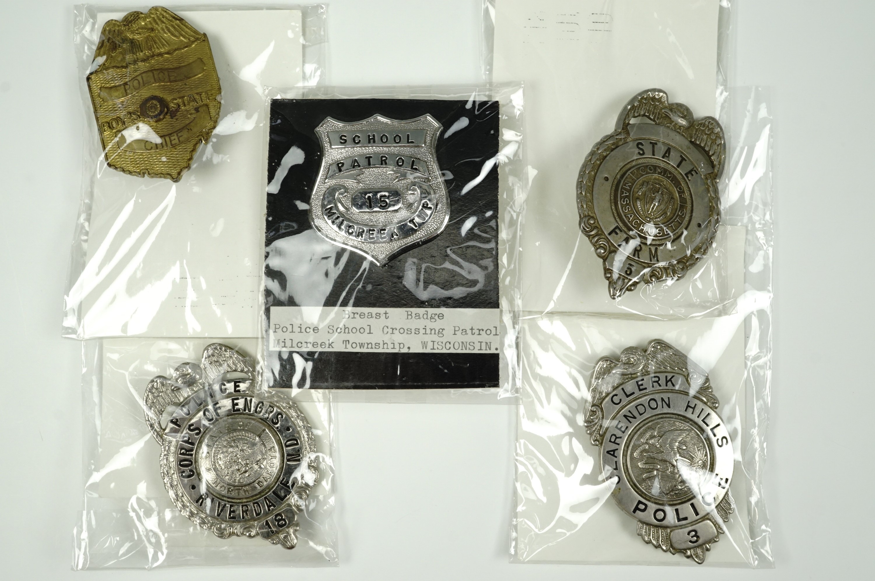 Five American police breast badges, comprising Massachusetts State Farm prison, Illinois clerk's