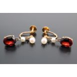 A pair of vintage garnet and pearls ear pendants, the oval cut stones (8 mm x 6 mm) claw set below