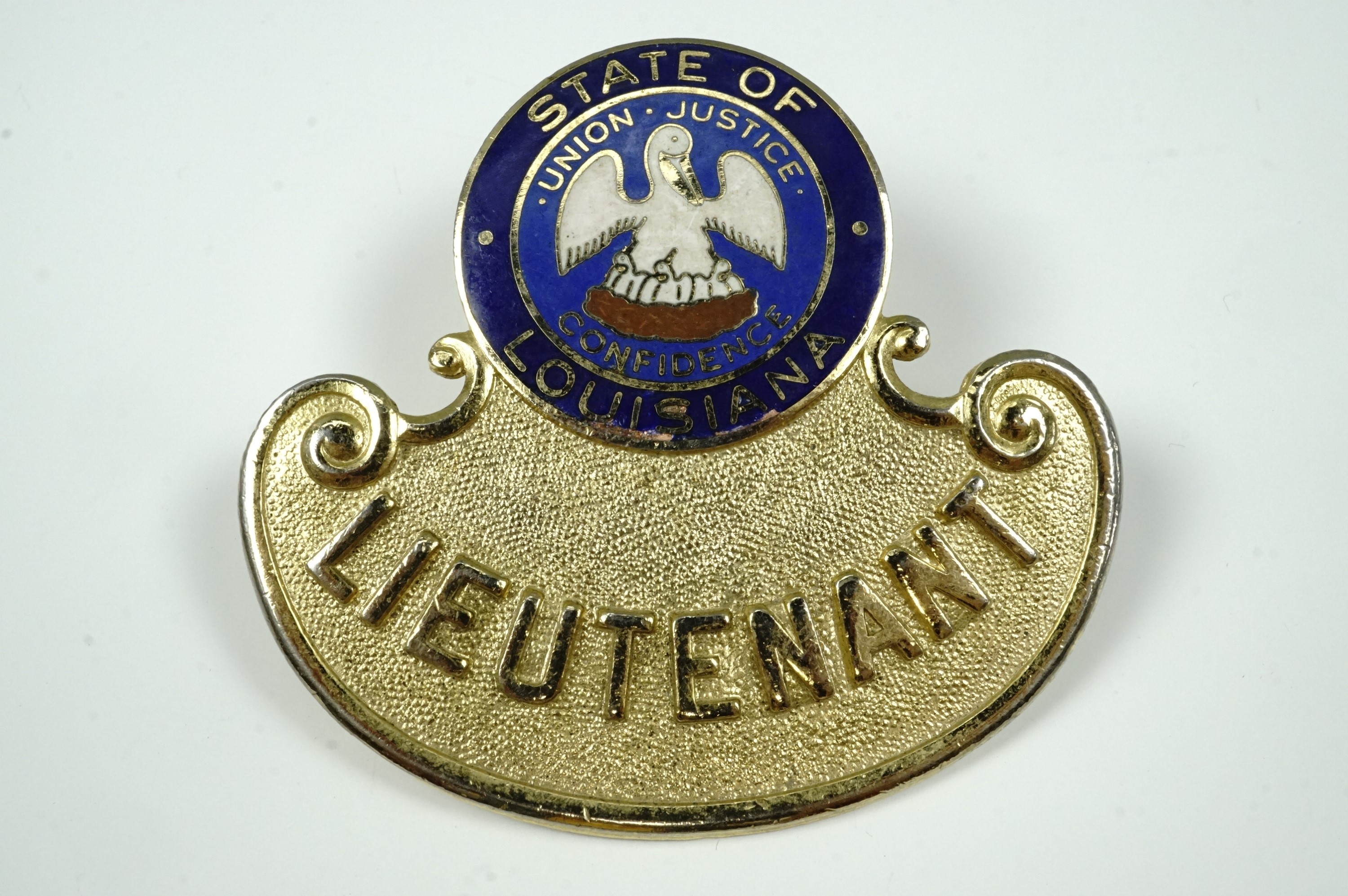 A State of Louisiana Lieutenant's American police cap badge, gilt metal and enamel,