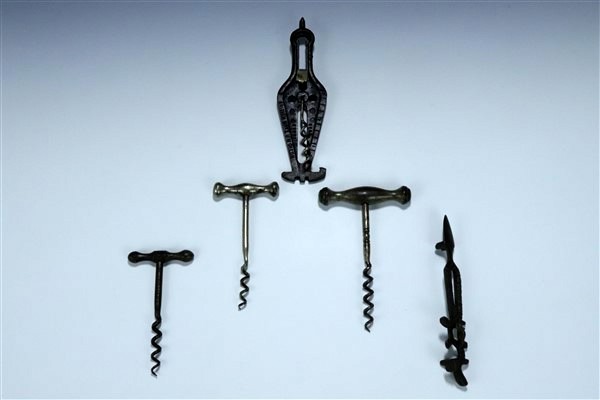 Two late 19th / early 20th Century cast steel combination corkscrews / tools together with three